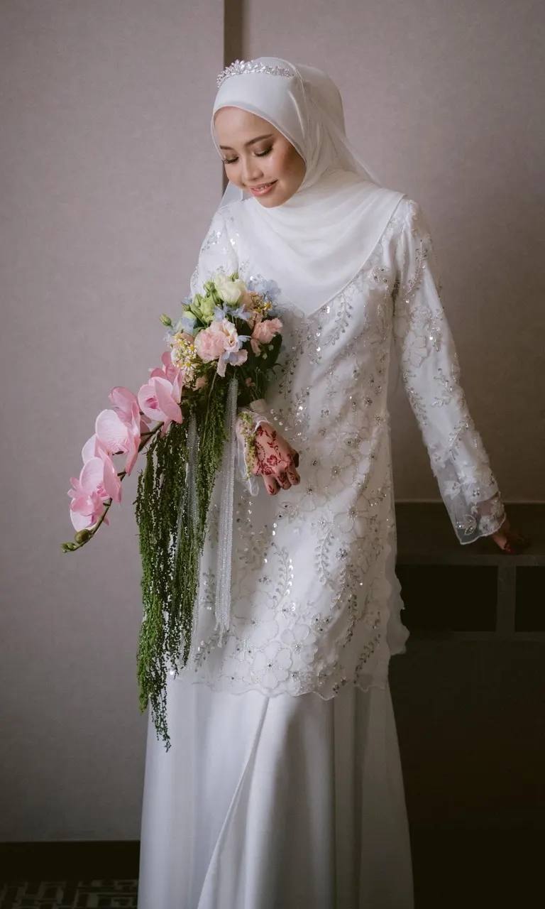 The finished gown: a sequinned lace kurung, worn by the bride on her nikah day